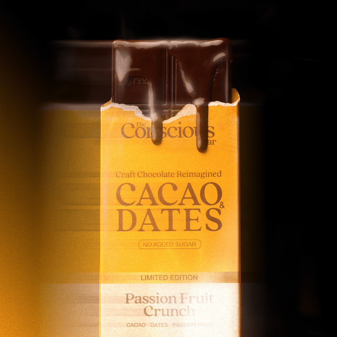 Box of Cacao & Dates chocolate bar with a drizzle of chocolate on top against a dark background