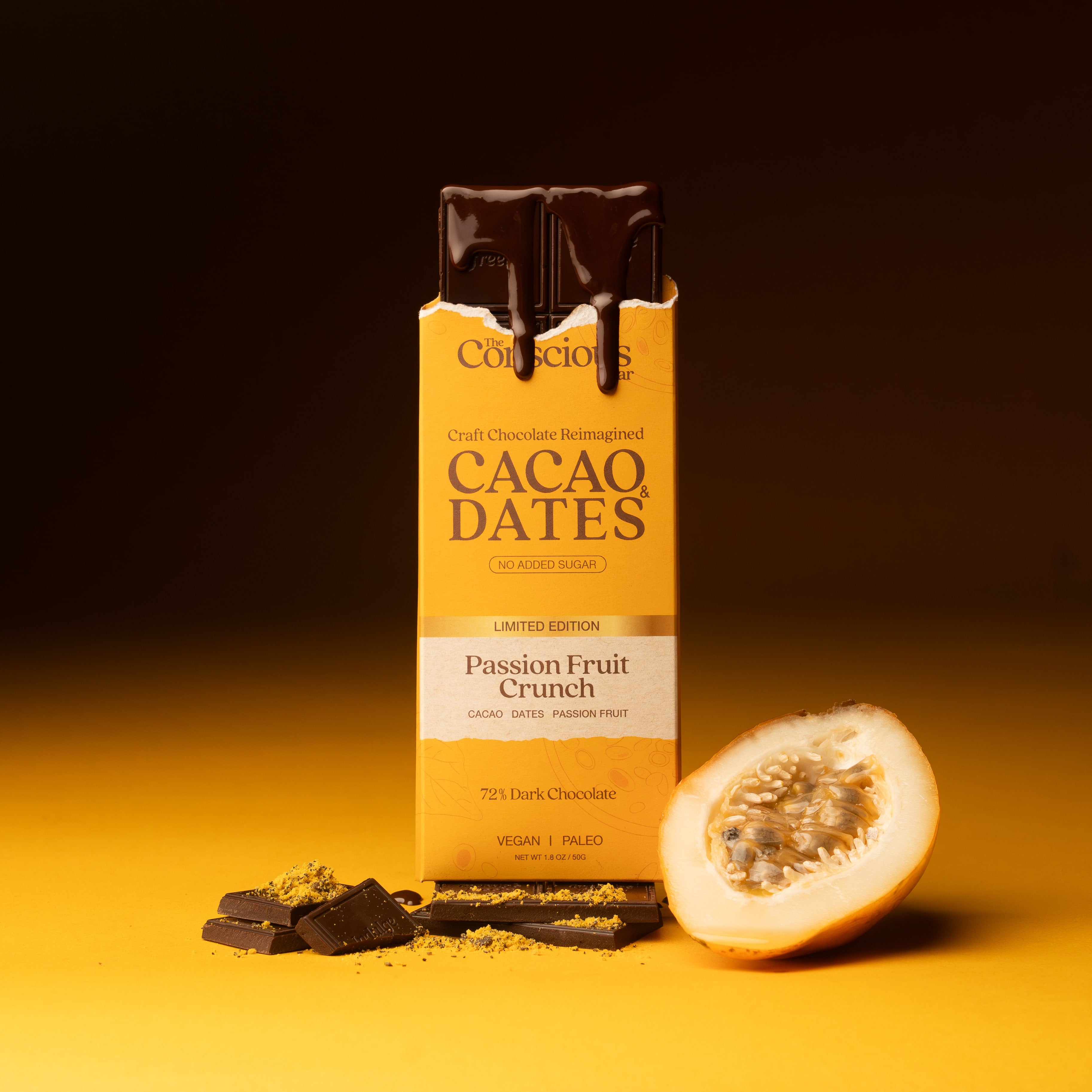 Cacao Dates Passion Fruit Crunch chocolate bar with a halved passion fruit on a yellow background